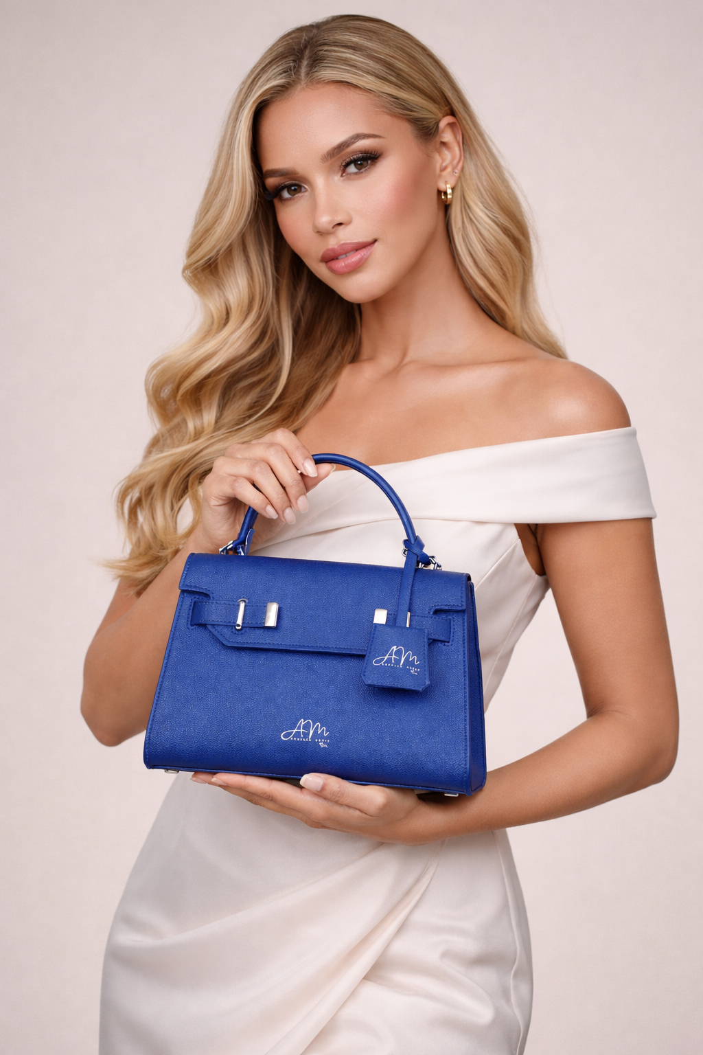Woman in champagne silk holding the Blue Dream handbag